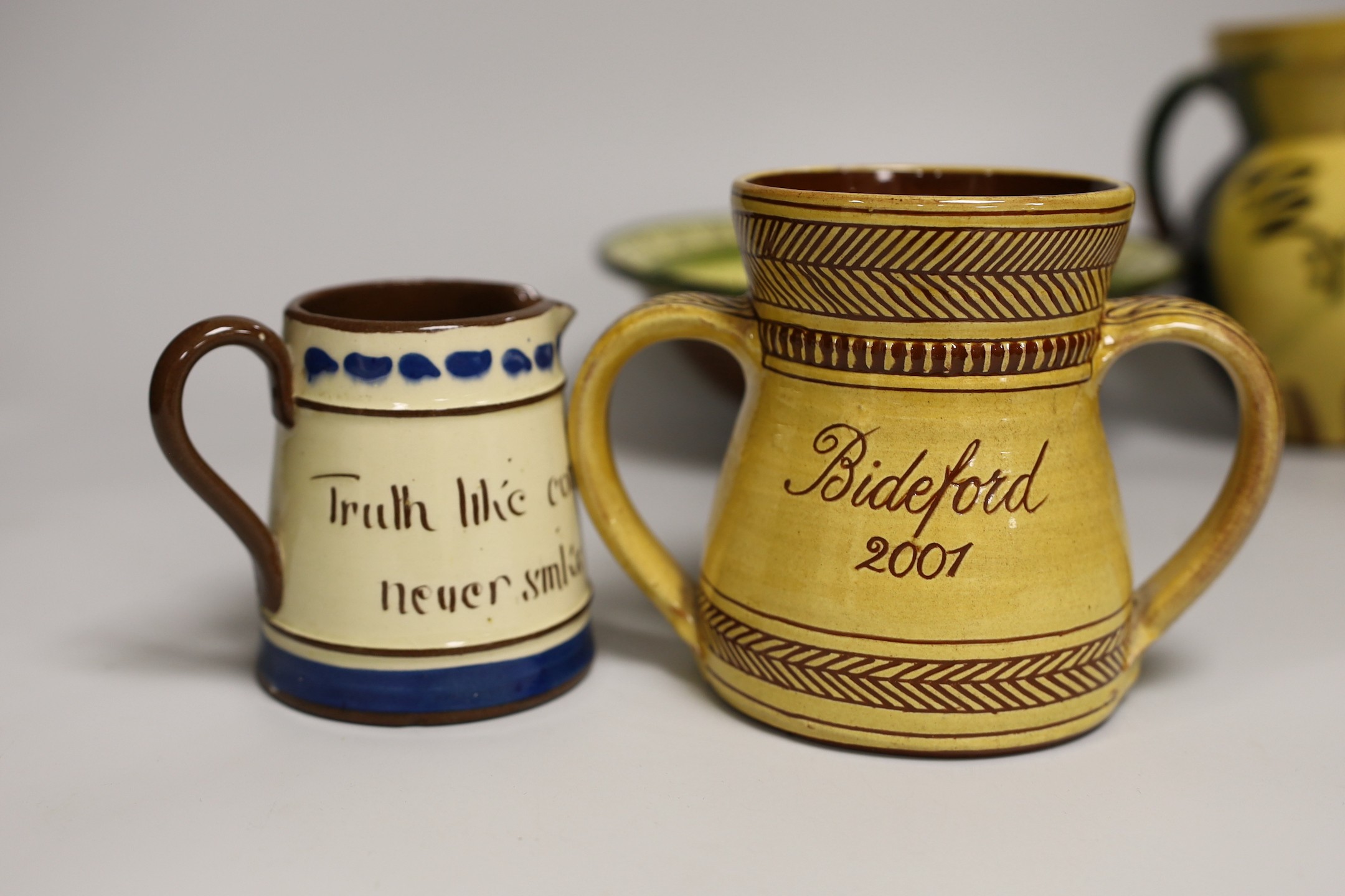 Margaret Brompton studio pottery bowl with insects, together with a slipware jug, a Longpark, Torquay small cockerel jug, and a Susan Juniper slipware jug, largest 21cm diameter, (4)